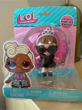 L.O.L. Surprise! Mini Doll in Black Dress with Silver Tiara and Pink Backing